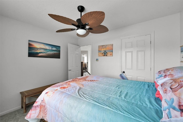 carpeted bedroom featuring baseboards and a ceiling fan