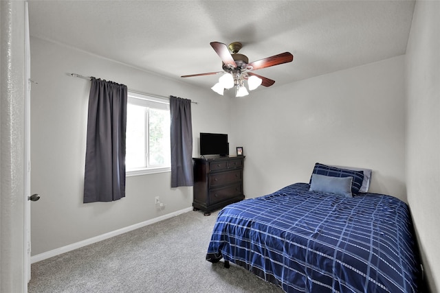 bedroom with ceiling fan, carpet floors, a textured ceiling, and baseboards