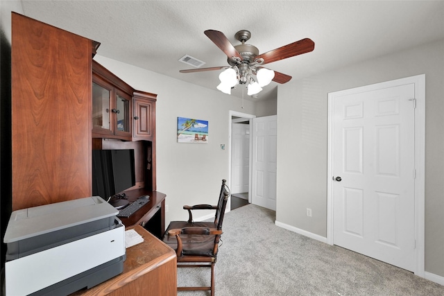 office featuring baseboards, visible vents, ceiling fan, and carpet flooring