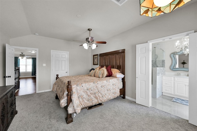 bedroom with lofted ceiling, carpet floors, ensuite bathroom, and baseboards