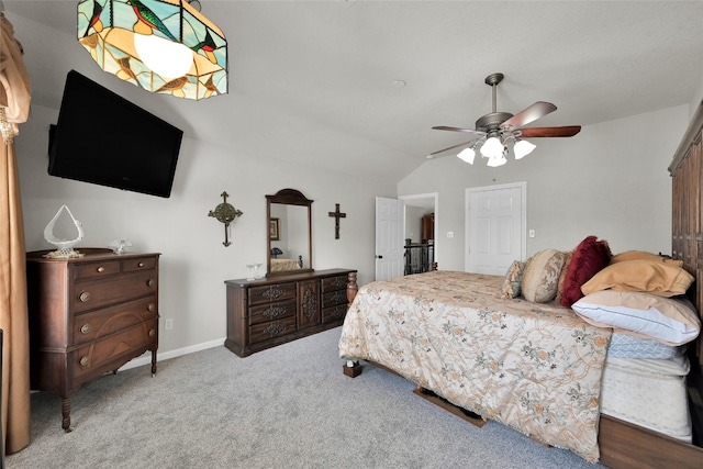 carpeted bedroom with vaulted ceiling, ceiling fan, and baseboards