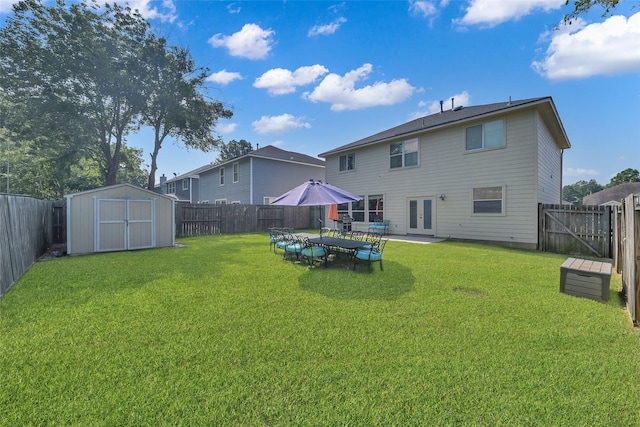 back of property featuring a yard, a shed, and a fenced backyard