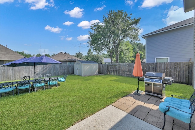 view of yard with a storage shed, a fenced backyard, a patio, and an outdoor structure