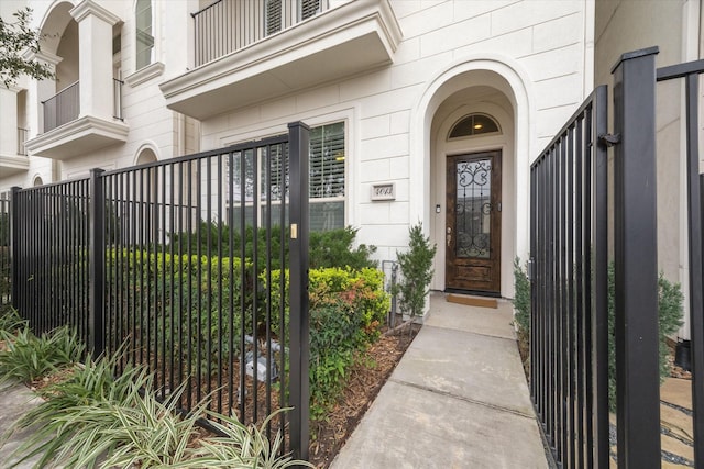 doorway to property with a gate and fence