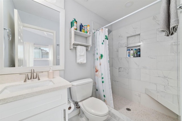 full bathroom with toilet, a shower stall, and vanity