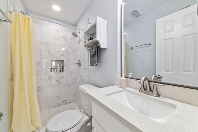 bathroom with a stall shower, visible vents, vanity, and toilet