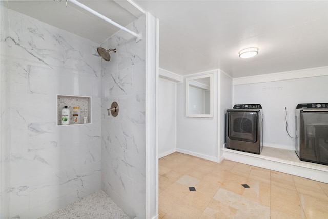 bathroom featuring washing machine and dryer and a marble finish shower