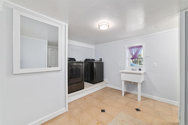 laundry area with baseboards, laundry area, and washer and dryer