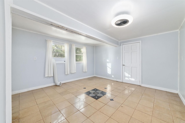 empty room featuring baseboards, crown molding, and light tile patterned flooring