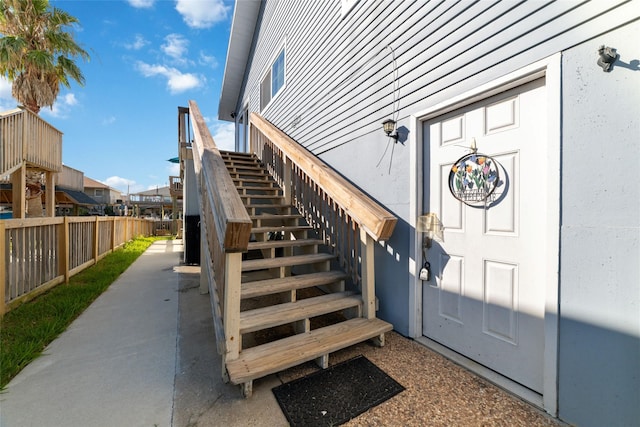 entrance to property featuring fence