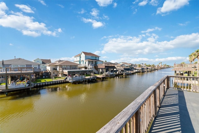 view of dock featuring a water view and a residential view