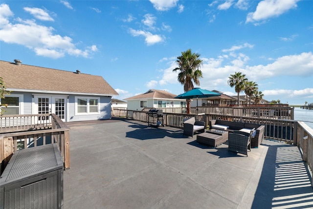 view of patio / terrace featuring an outdoor hangout area, french doors, grilling area, and a deck with water view