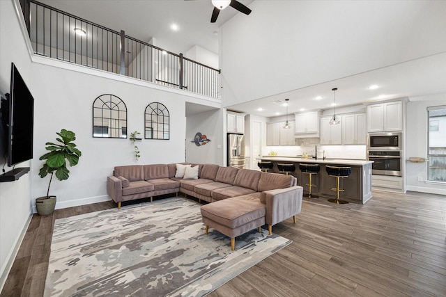 9410 Knollwood Ln, Missouri City, TX 77459 - living room featuring ceiling fan, baseboards, dark wood-type flooring, and recessed lighting