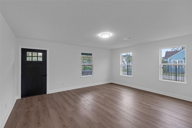 foyer featuring dark wood-style flooring, visible vents, and baseboards