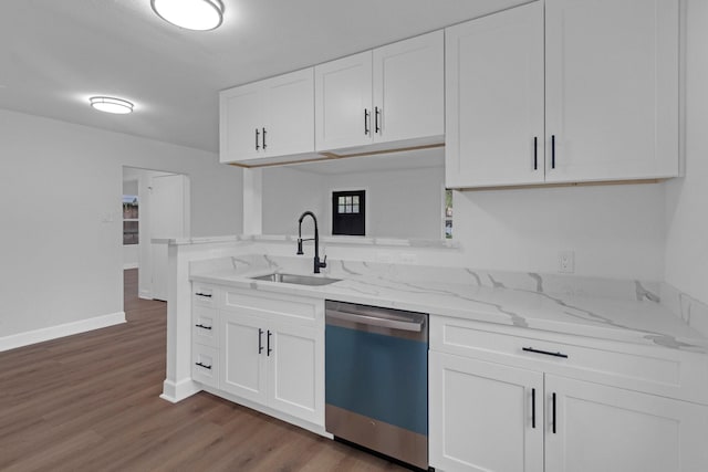 kitchen featuring white cabinets, a sink, stainless steel dishwasher, and light stone countertops