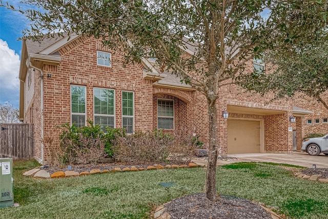 view of front of home with brick siding, roof with shingles, concrete driveway, fence, and a front lawn