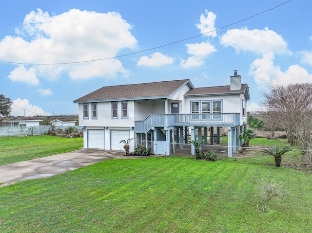 view of front facade featuring a chimney, fence, concrete driveway, and a front yard