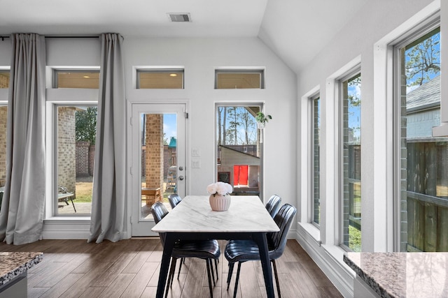 sunroom featuring visible vents and vaulted ceiling