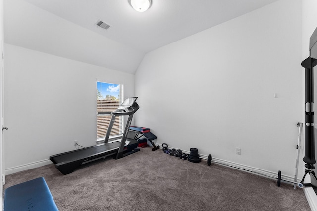 exercise room featuring lofted ceiling, dark colored carpet, visible vents, and baseboards