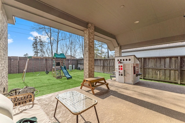 view of patio / terrace with a playground and a fenced backyard