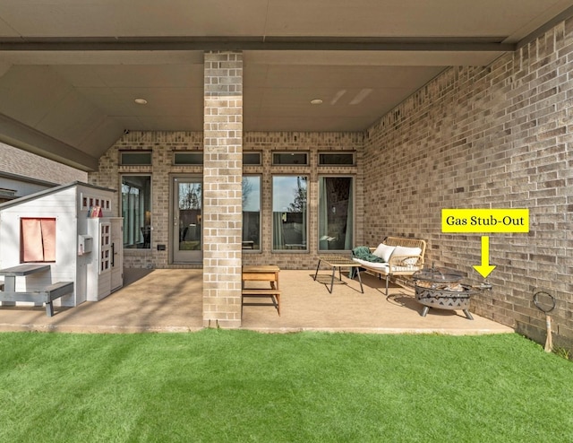 view of patio / terrace with an outdoor living space with a fire pit