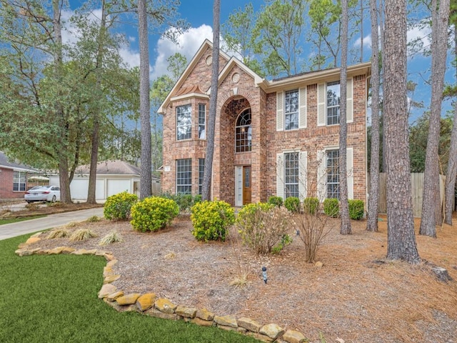 view of front of property with an outbuilding and brick siding