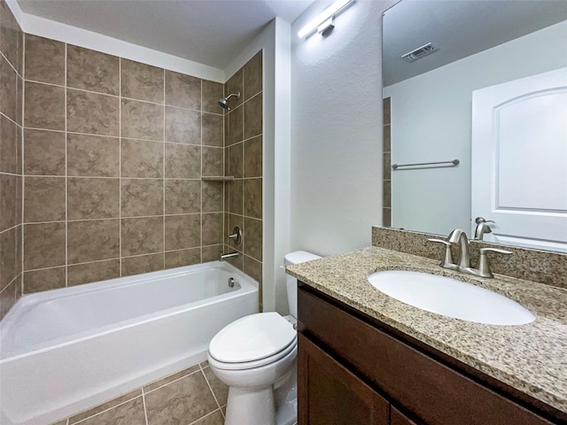 bathroom with toilet, vanity, visible vents, tile patterned floors, and washtub / shower combination