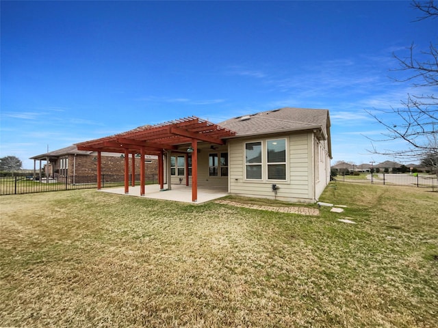 back of house featuring a shingled roof, fence, a yard, a pergola, and a patio area