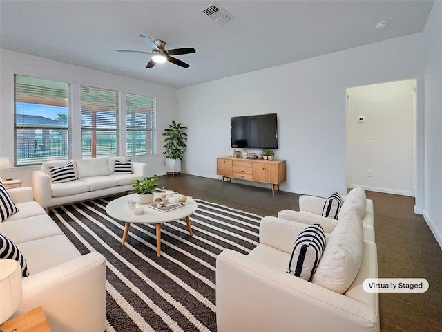 living room featuring visible vents and ceiling fan