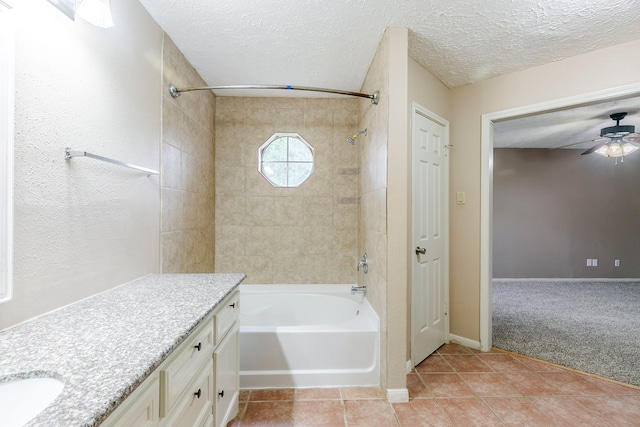 bathroom with shower / bathing tub combination, ceiling fan, a textured ceiling, vanity, and tile patterned floors