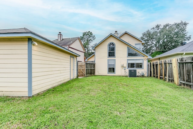 rear view of property featuring a fenced backyard, a lawn, and central air condition unit