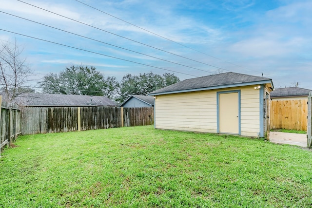 view of yard featuring a storage unit, an outdoor structure, and a fenced backyard