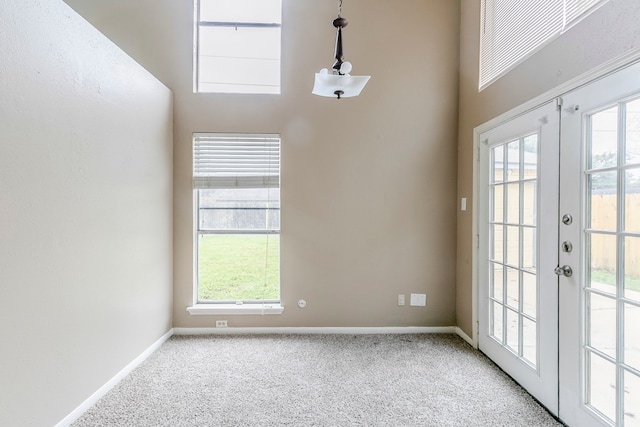 interior space with french doors, light carpet, and baseboards