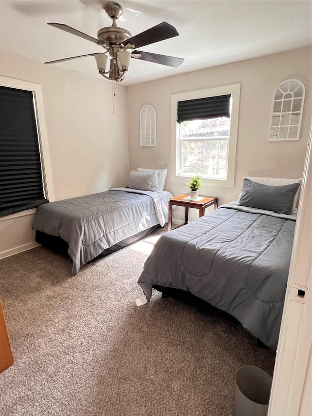 bedroom featuring carpet floors, ceiling fan, and baseboards