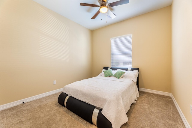 bedroom featuring baseboards, a ceiling fan, and light colored carpet