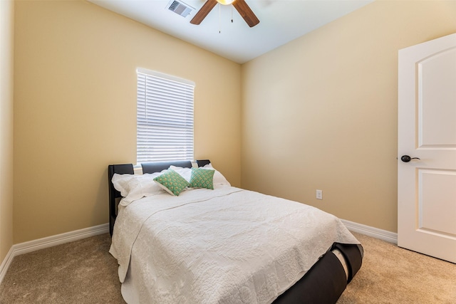 bedroom with baseboards, a ceiling fan, visible vents, and light colored carpet