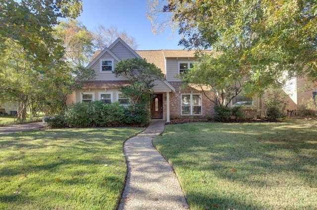 view of front facade with a front yard and brick siding