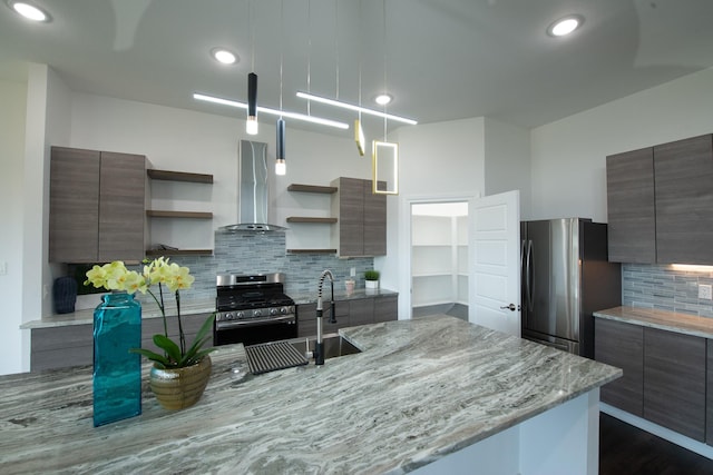 kitchen featuring light stone counters, stainless steel appliances, range hood, open shelves, and modern cabinets