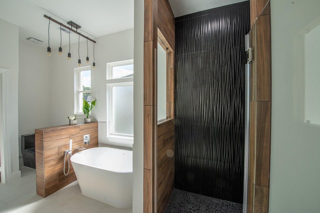 full bathroom with a freestanding bath, walk in shower, and visible vents