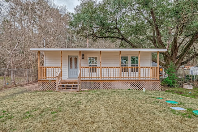 single story home featuring a porch, fence, and a front yard