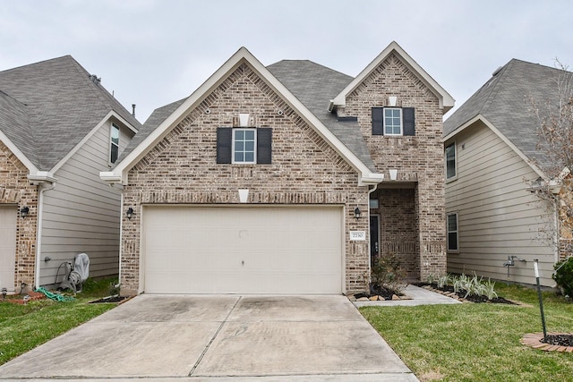 view of front of property with driveway, an attached garage, a front yard, and brick siding