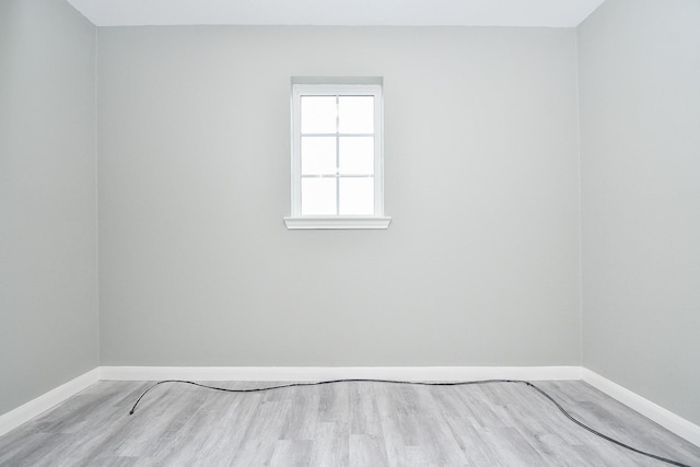 unfurnished room with light wood finished floors and baseboards