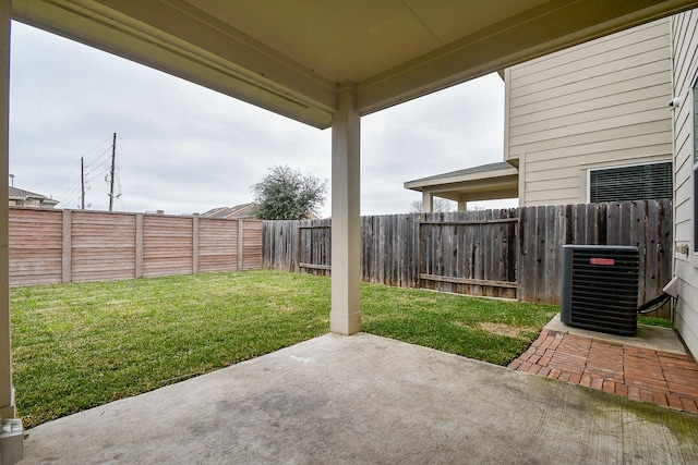 view of patio with cooling unit and a fenced backyard