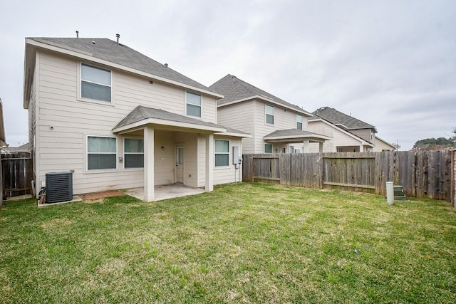 rear view of property featuring a patio area, a lawn, a fenced backyard, and central AC unit