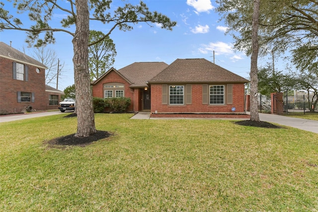 ranch-style home with roof with shingles, fence, a front lawn, and brick siding