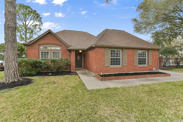 single story home with a shingled roof, brick siding, and a front lawn