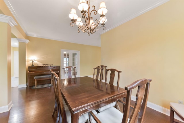 dining area featuring baseboards, dark wood-style floors, ornamental molding, french doors, and ornate columns