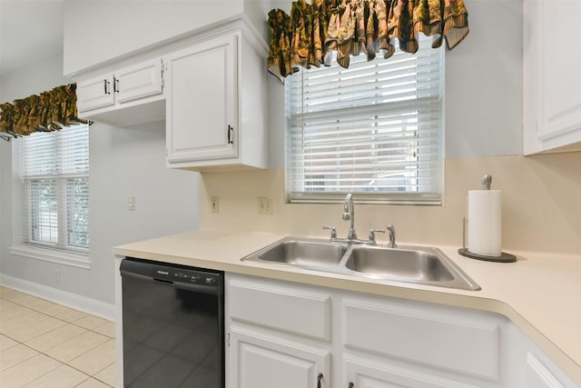 kitchen featuring light tile patterned floors, dishwasher, light countertops, white cabinetry, and a sink