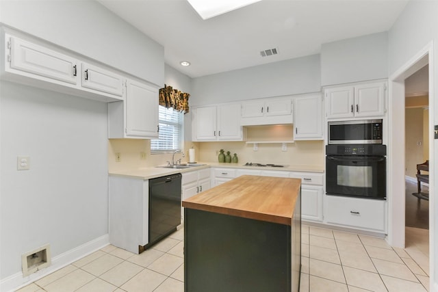 kitchen with light tile patterned floors, visible vents, black appliances, white cabinetry, and a sink