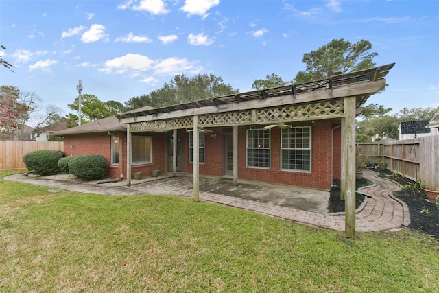 back of property featuring fence private yard, a patio area, a lawn, and brick siding